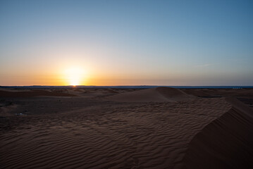 Merzouga, Erg Chebbi, Morroco, Africa - April 30, 2019: Sun rises from the dunes