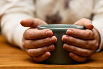 Young wooman drinking hot cocoa or coffee. Autumn or winter moody weekend, New Year and Christmas background. Lazy day, quarantine, stay home, cosy scene, hygge concept.