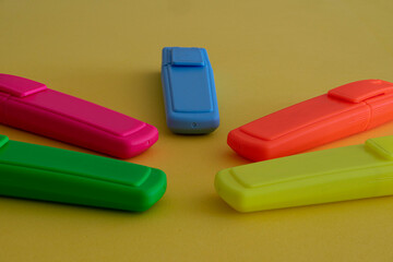 highlighter pencils. various colors on yellow background