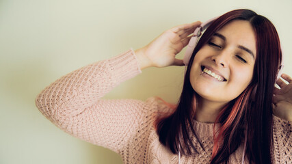 Fototapeta premium happy woman listening to music through her headphones