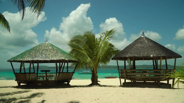 Tropical beach and summer houses, bungalows by the turquoise sea. Summer and travel vacation concept