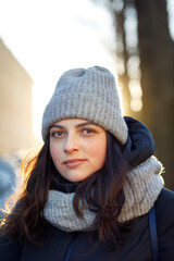 portrait of a woman in the city in a down jacket and a hat
