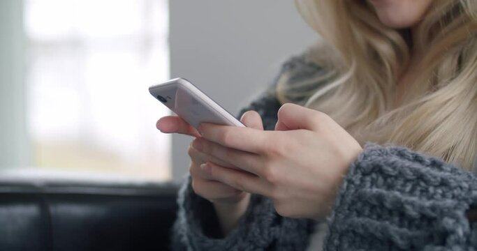 Woman Texting Typing Scrolling on Mobile Phone Smartphone in Bright Living Room
