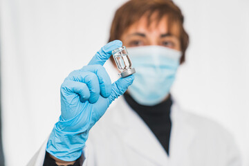 Coronavirus cure. Doctor or scientist in the laboratory with a syringe with the cure of covid-19....