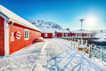 Traditional Norwegian red wooden houses on the shore of  Sundstraumen strait