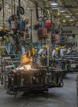 Workers welding car window