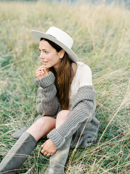 lovely girl resting while sitting in the grass