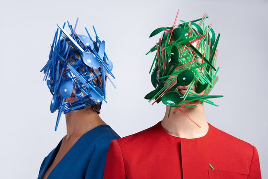 people having colorful plastic trash on their faces