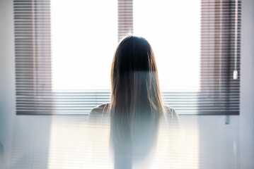 Unrecognizable woman in light room