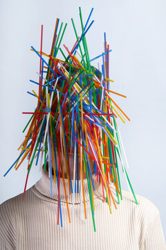 human face covered with colorful plastic straws
