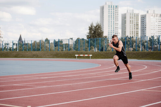 Sprinter running fast on stadium track