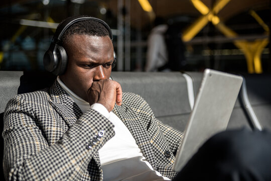 Business Black Man Waiting Watching A Movie On Tablet At The Airport