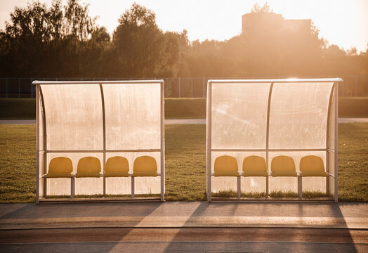 Chairs under transparent canopy along treadmill in bright day