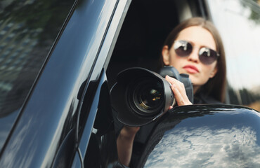 Private detective with camera spying from car, focus on lens