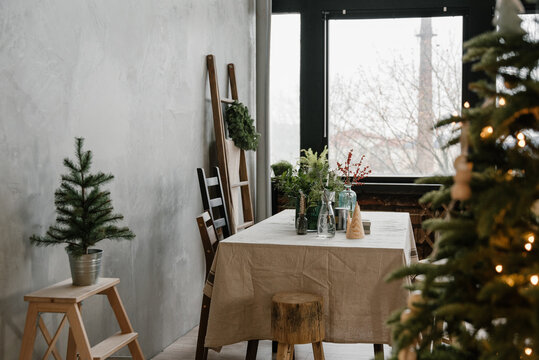Decorated table in spacious loft on Christmas Day