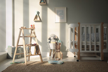 Beautiful baby room interior with stylish wooden ladder