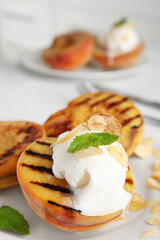Delicious grilled peach with ice cream served on plate, closeup