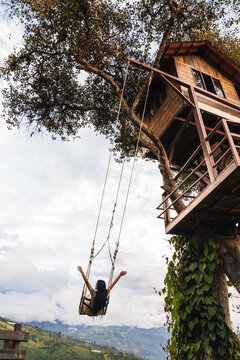 Young woman swinging with open arms