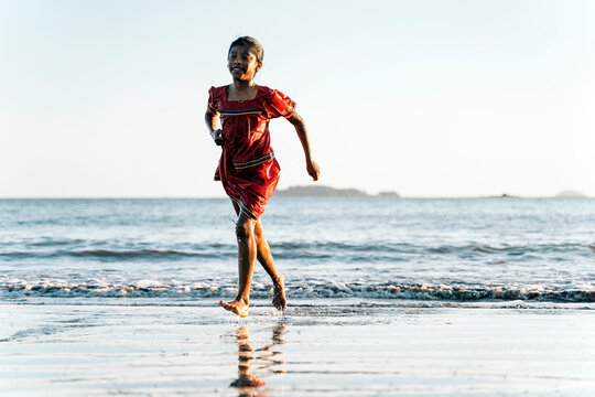 Cute panamanian kid having fun and walking in the beach