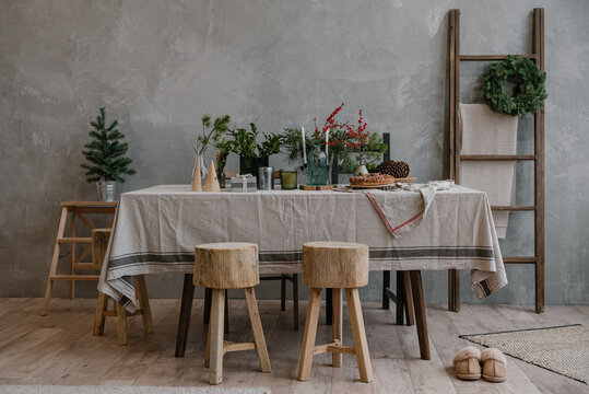 Stools near table decorated for Christmas dinner