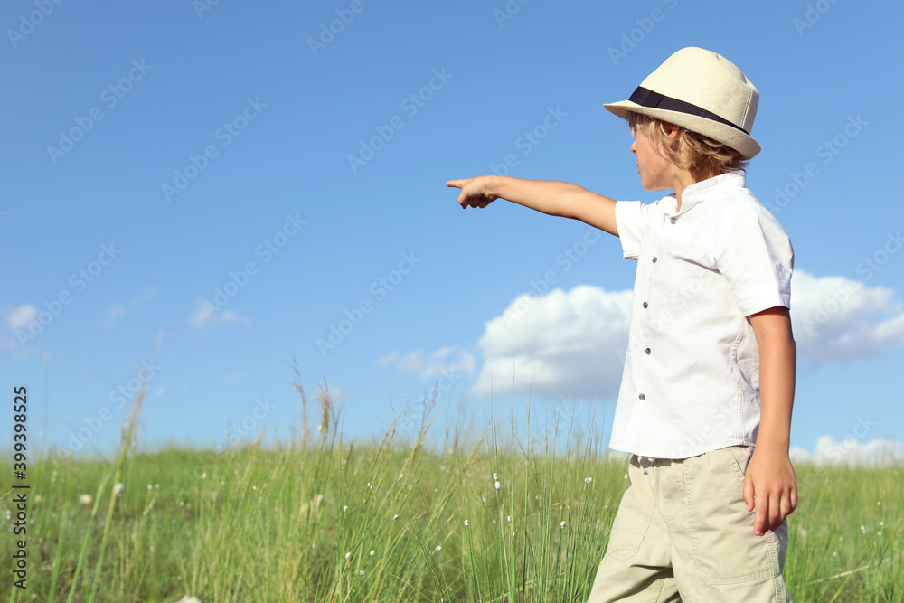 Sticker Cute little boy wearing stylish hat outdoors, space for text. Child spending time in nature