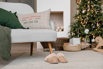 Sofa and slippers in cozy living room on Christmas Day