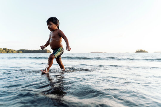 Cute panamanian kid having fun and walking in the beach