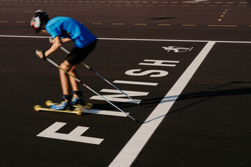 Teen roller skier crossing finish line