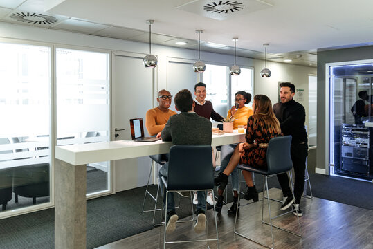 Business partners chatting on coffee break in office