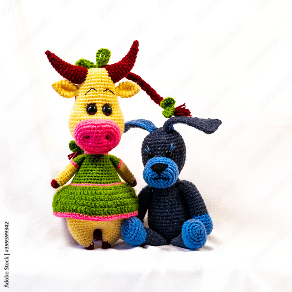 Canvas Prints Two Amigurumi dolls a cow and a dog. Photo on a white background.