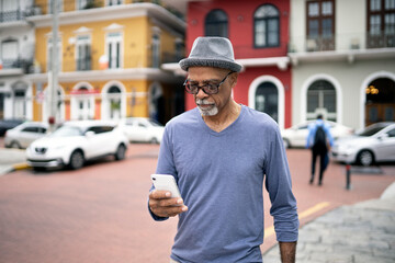 Senior black man using mobile phone.