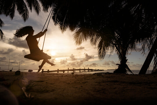 Woman swinging on an island.