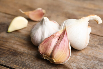 Fresh organic garlic on wooden table, closeup