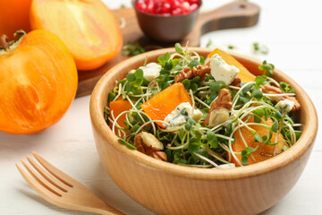 Delicious persimmon salad served on white table, closeup