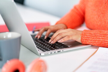 Close up of a woman typing.