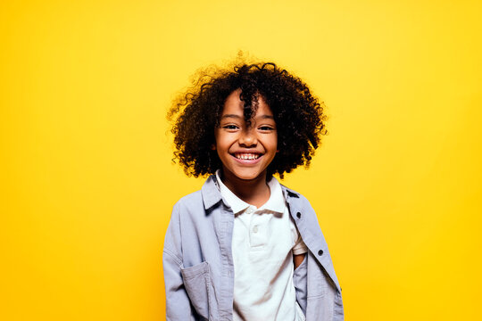 Black kid in studio smiling.