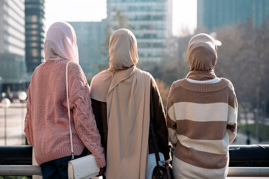 Three muslim women close from the side.