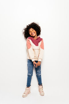 Black kid in studio smiling.