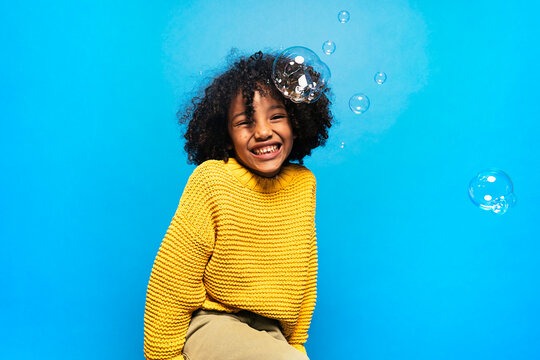 Black kid in studio laughing.