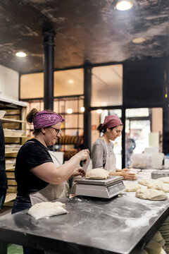 Women in bakery preparing dough.
