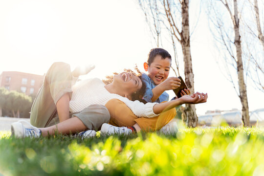 Afro and asian children laughing.