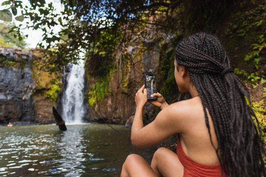 African girl enjoying a waterfall