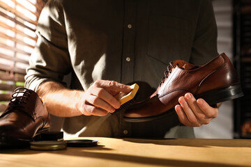 Master taking care of shoes in his workshop, closeup