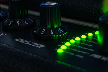 Detail of an amplifier for electric guitar with green lights