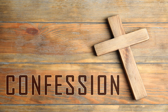 Christian cross and word Confession on wooden background, top view