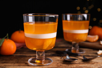 Delicious tangerine jelly on wooden table, closeup