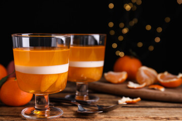 Delicious tangerine jelly on wooden table. Space for text