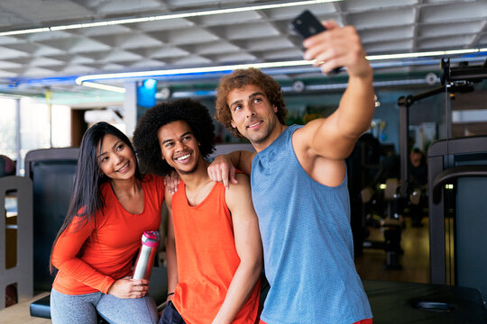 Group of friends taking a selfie at gym.