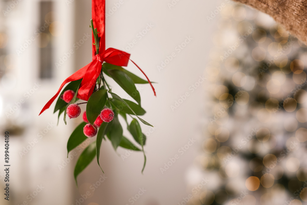 Canvas Prints Mistletoe bunch with red bow hanging indoors, space for text. Traditional Christmas decor