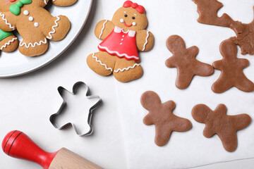 Flat lay composition with homemade gingerbread man cookies on light table